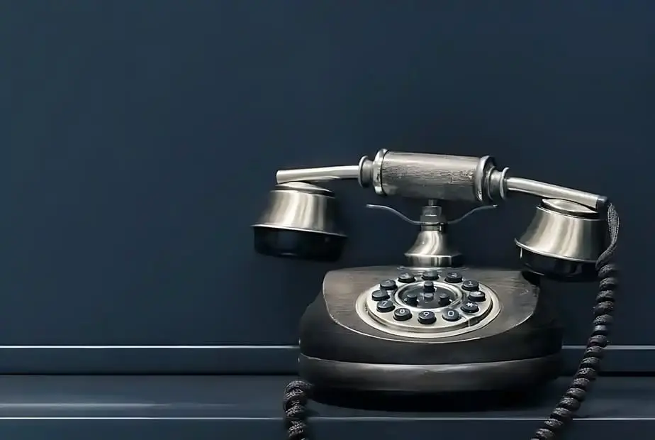 A black and silver telephone sitting on top of a table.