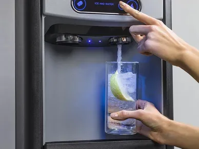 A person is using an automatic water dispenser.