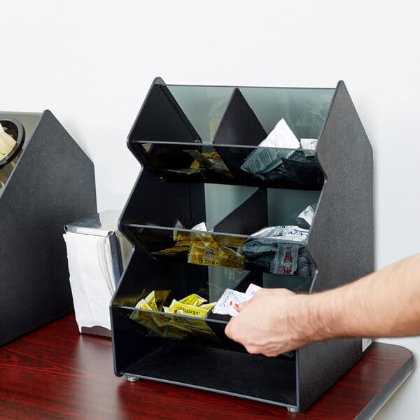 Black condiment organizer with multiple compartments.