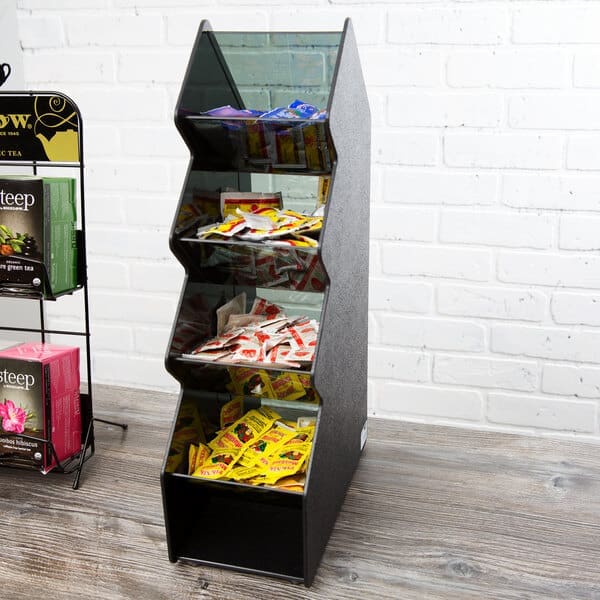 Black tiered dispenser with tea packets.