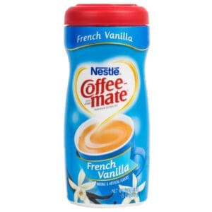 A container of Coffee-Mate French Vanilla Non-Dairy Powder Creamer. The packaging is blue with a picture of a coffee cup and vanilla flowers.