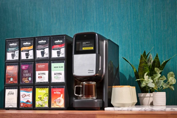 Coffee machine with various coffee pods and mugs.