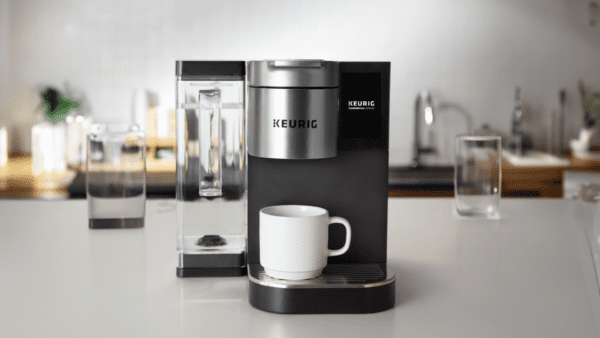 A coffee maker with a cup on the counter.