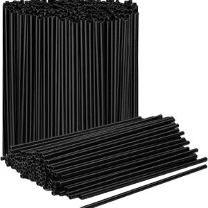 A stack of Berkley Square Stirrer 5" Plastic Stirrers, with several individual stirrers lying horizontally in front of the stack.