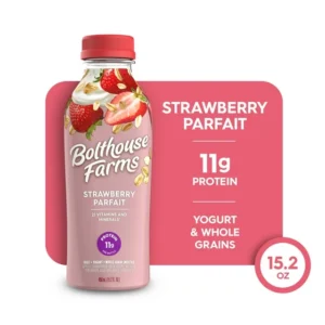 A Bolthouse Farms Fruit Smoothie, Strawberry Parfait bottle, displaying nutritional information, against a pink background.