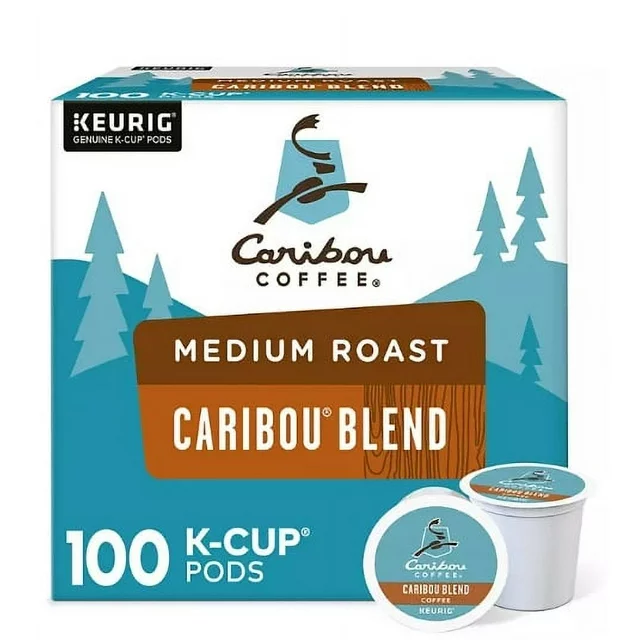 A box of 100 Caribou Coffee Medium Roast K-Cup Pods, Caribou Blend featuring medium roast caribou blend, advertised with a blue package and tree graphics.