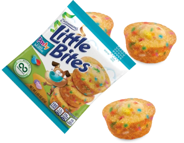 A package of Entenmann's Little Bites Party Cake Muffins displayed alongside two muffins with colorful sprinkles, isolated on a white background.