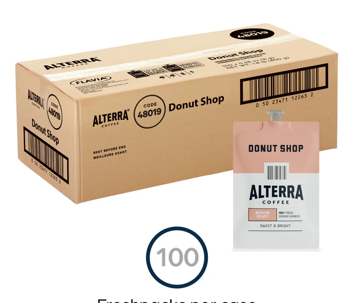 A cardboard box labeled "FLAVIA ALTERRA Coffee, Donut Shop Blend" with a visible bar code and coffee label, indicating it contains 100 coffee pods.