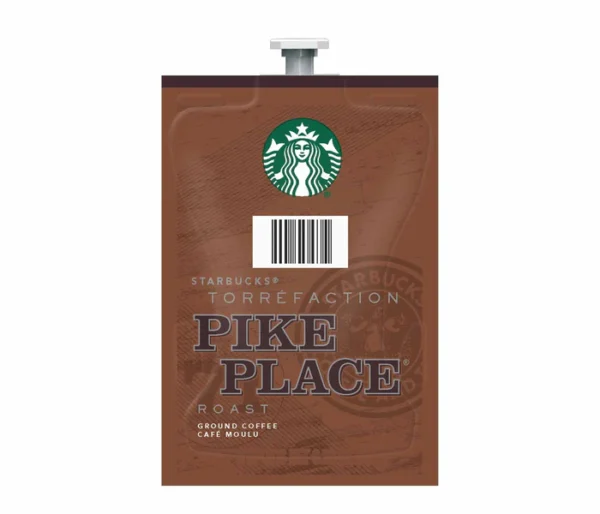 A FLAVIA Starbucks® Pike Place Roast Coffee pack in a flat, flexible pouch with a twist cap, featuring the starbucks logo and title in bold letters.