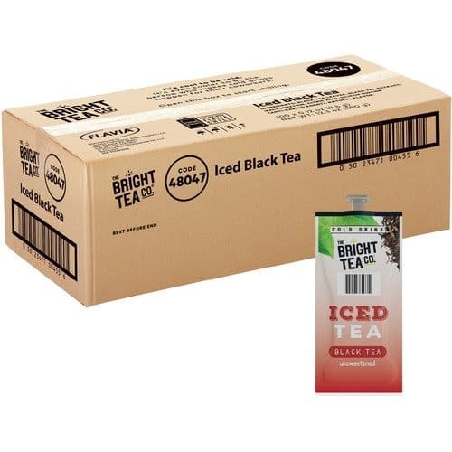 A cardboard shipping box labeled "FLAVIA The Bright Tea Co. Unsweetened Iced Black Tea Freshpack" beside a carton of the same unsweetened iced black tea.