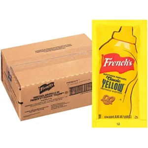 A box of French's Mustard Single-Serve Packets beside a packet of the mustard.