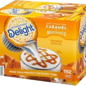 Box of International Delight Caramel Macchiato Coffee Creamer Singles, depicting a cup of coffee being served creamer.