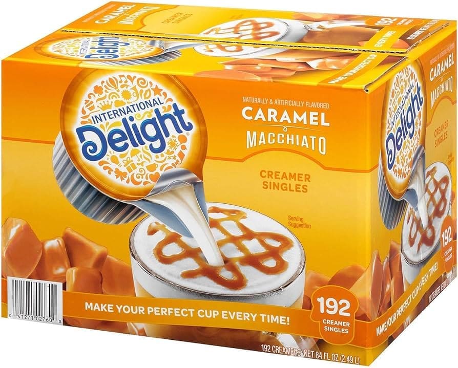 Box of International Delight Caramel Macchiato Coffee Creamer Singles, depicting a cup of coffee being served creamer.