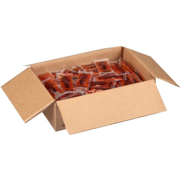 Box full of individual hot sauce packets.