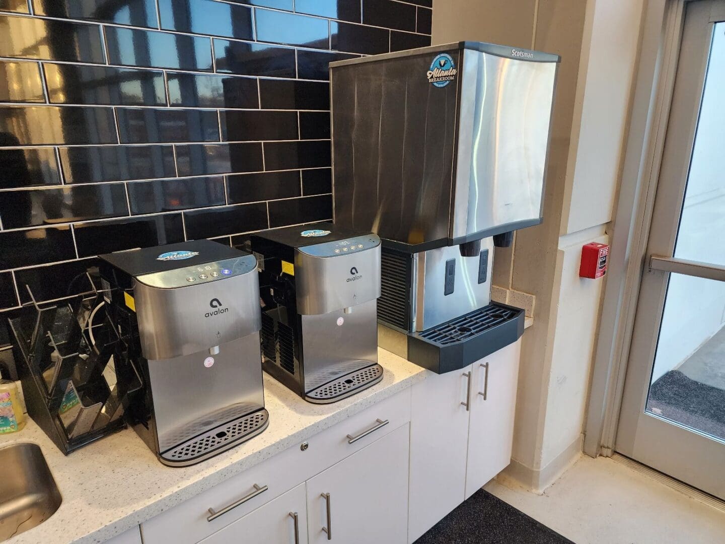 Two water coolers and an ice machine.