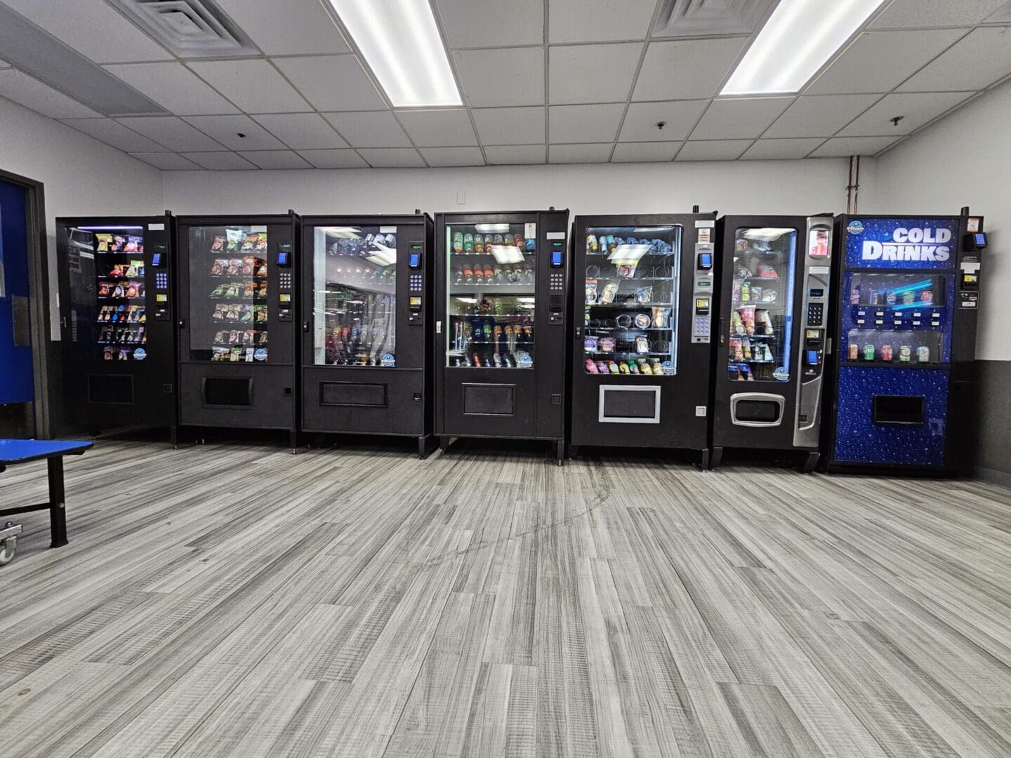 Row of vending machines in a room.