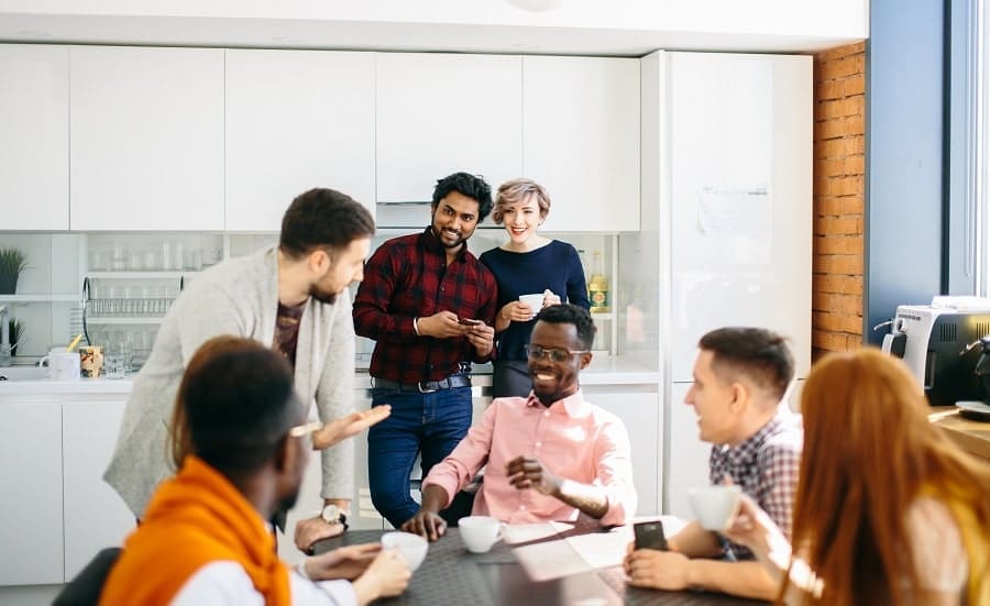 Group of colleagues gathered in a kitchen.